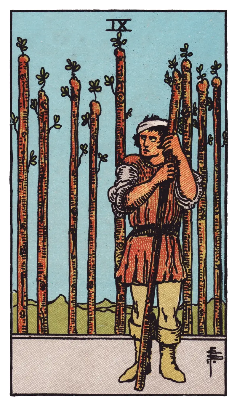 Nine of Wands tarot card — bandaged figure leaning on a wand, glancing warily over one shoulder at a barrier of eight staves, Rider-Waite-Smith deck