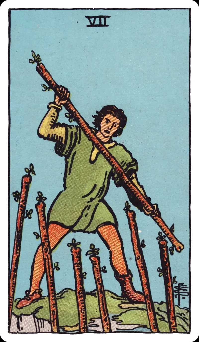 Seven of Wands tarot card — figure on high ground wielding a wand against six staves thrust up from below, Rider-Waite-Smith deck
