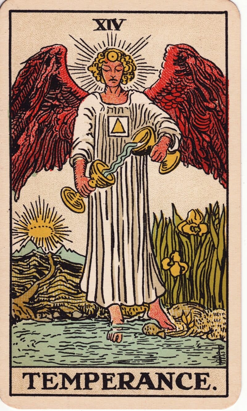 Temperance tarot card — winged angel pouring water between two cups with one foot on land and one in water, Rider-Waite-Smith deck