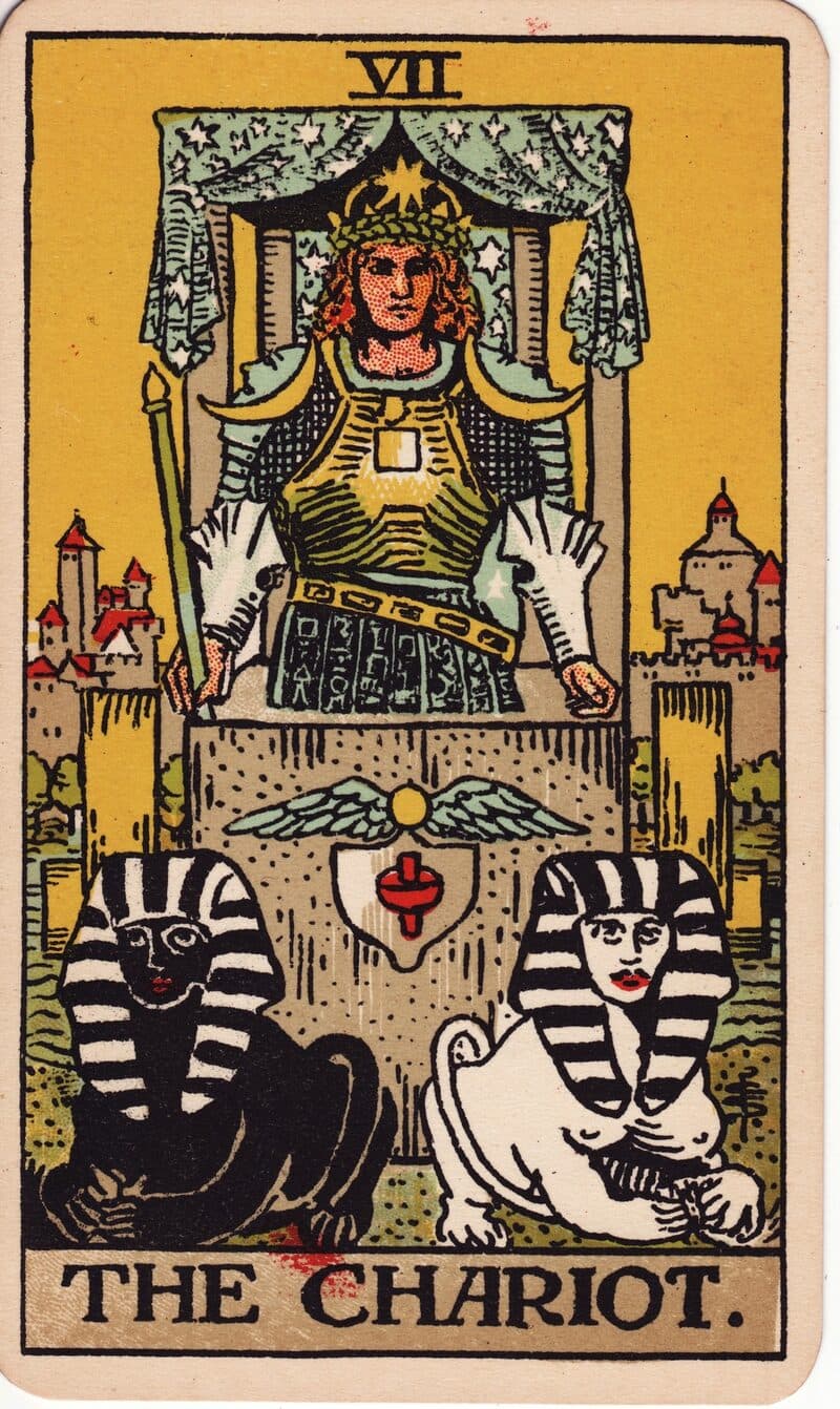 The Chariot tarot card — armored figure in stone chariot driven by black and white sphinxes, Rider-Waite-Smith deck