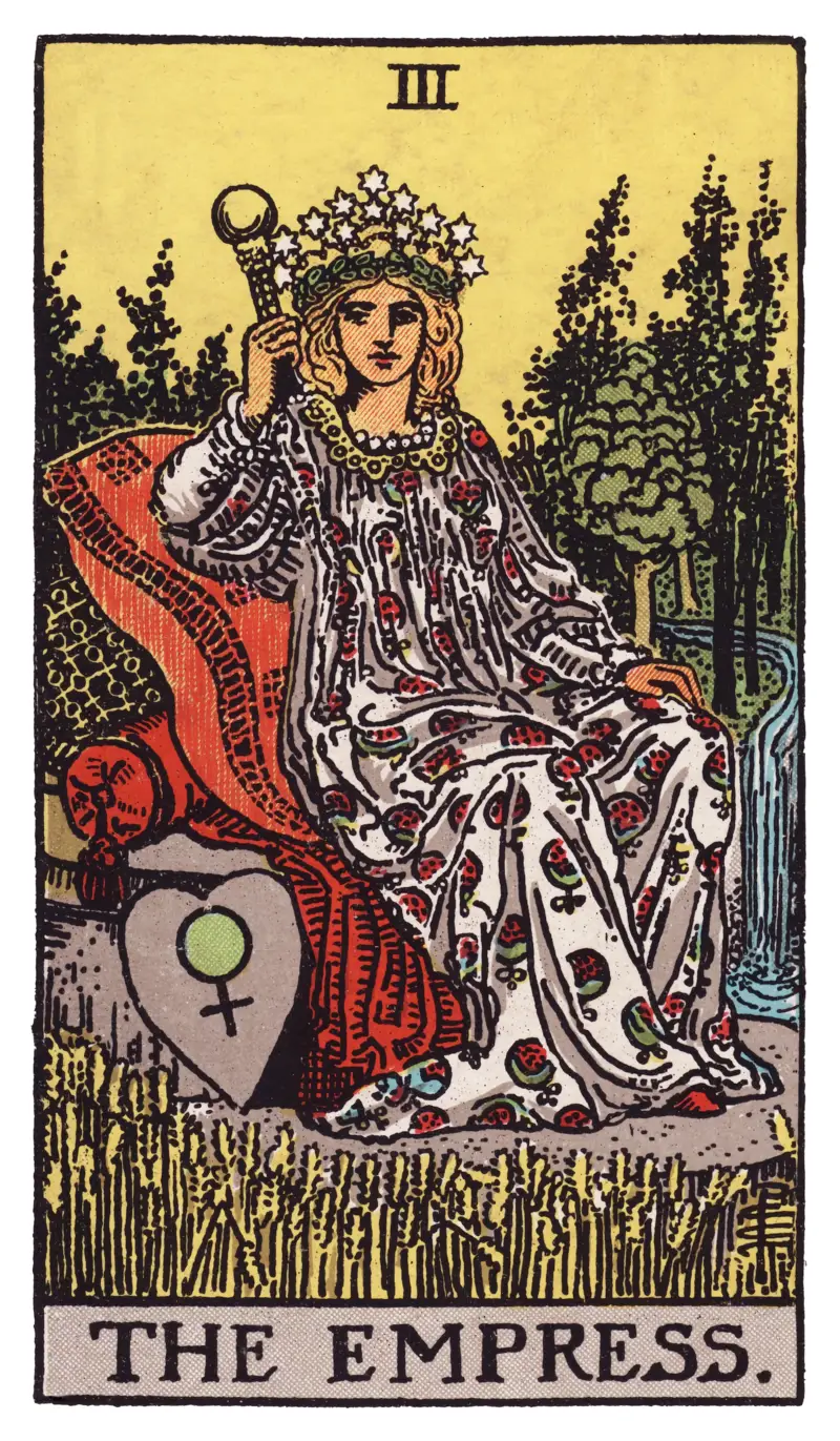 The Empress tarot card — crowned figure on cushioned throne amid wheat field with Venus shield, Rider-Waite-Smith deck
