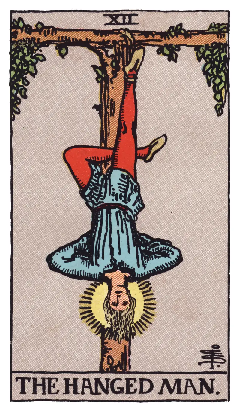 The Hanged Man tarot card — figure suspended upside-down from a living tau cross with a halo of light, Rider-Waite-Smith deck