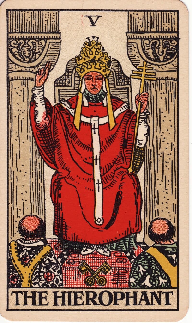 The Hierophant tarot card — robed figure between two pillars blessing two kneeling supplicants, Rider-Waite-Smith deck