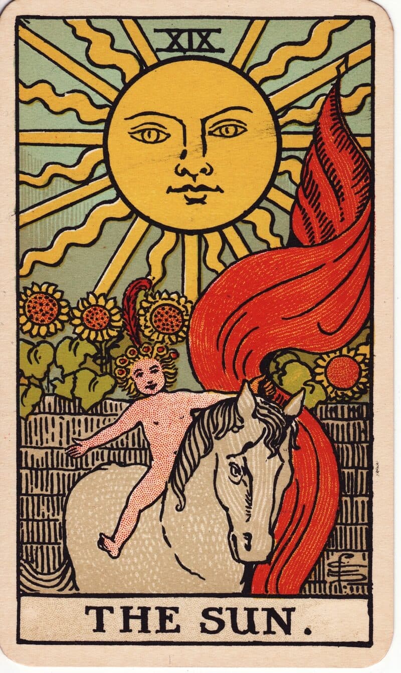 The Sun tarot card — child on white horse beneath a radiant sun with sunflowers, Rider-Waite-Smith deck