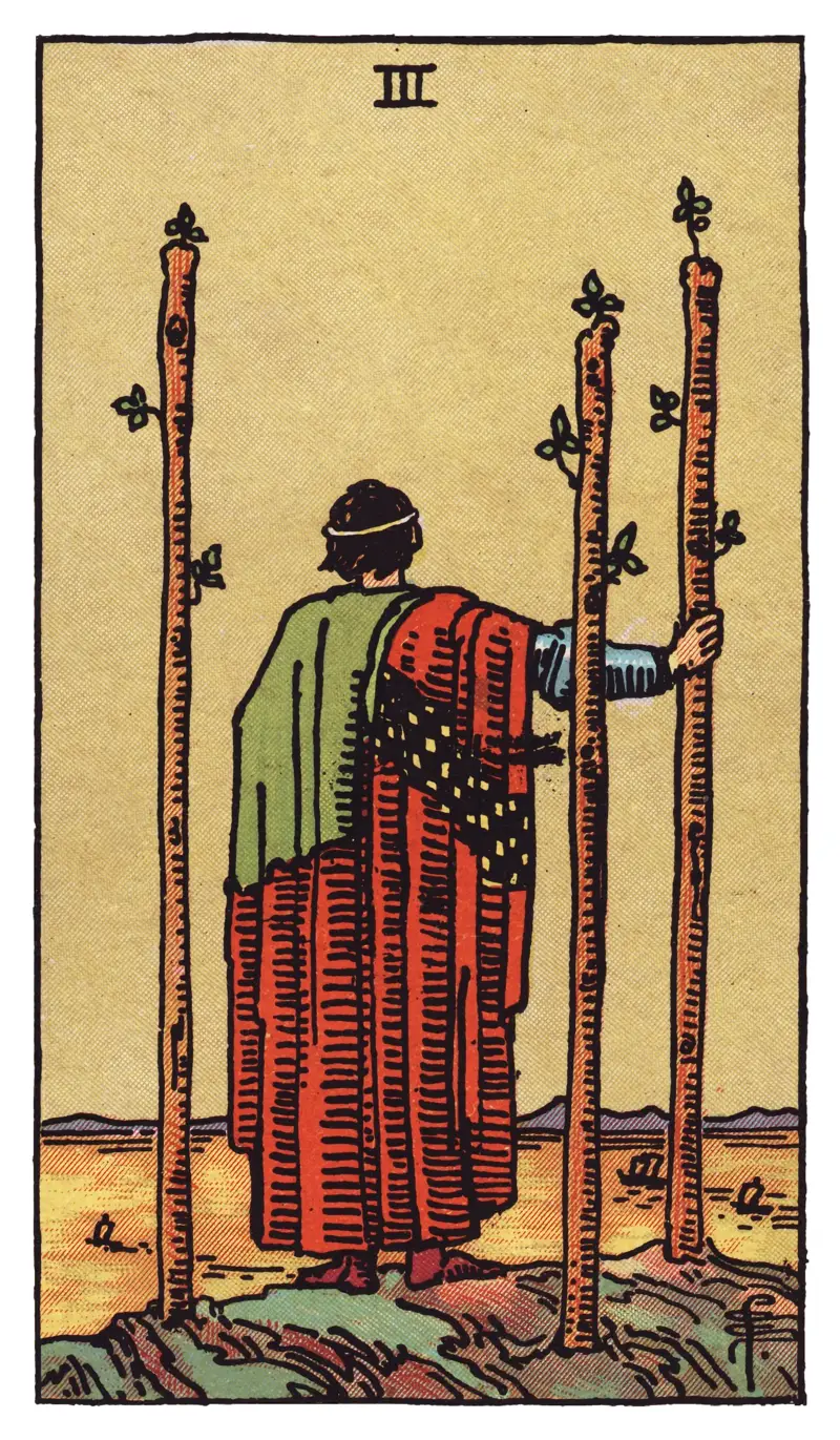 Three of Wands tarot card — robed figure on a cliff beside three planted wands, watching ships cross a golden sea, Rider-Waite-Smith deck