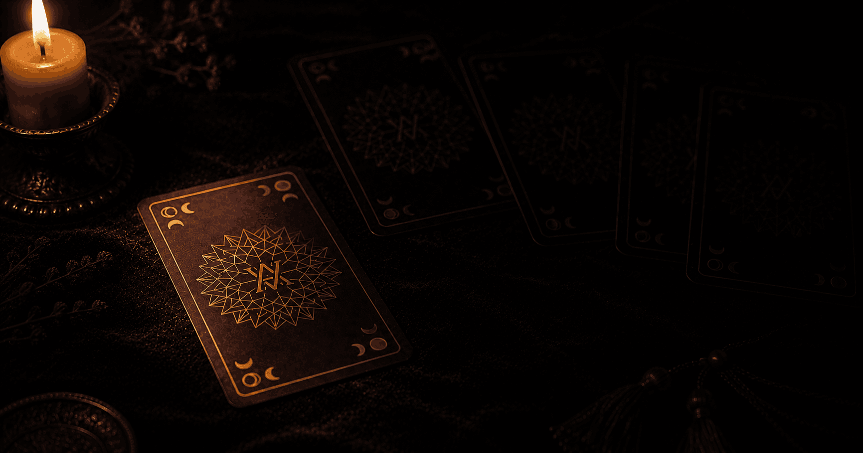 A tarot card half-lit on a dark table, the rest of the spread fading into shadow